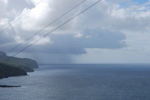 Rain storm and waterspout starting down from a cloud off the south coast of Hiva Oa